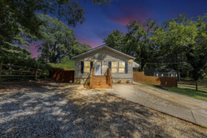 Evening photo of the front of the property with a beautiful purple sky