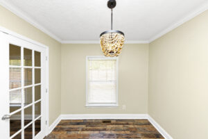 Spare bedroom with chandelier and french doora